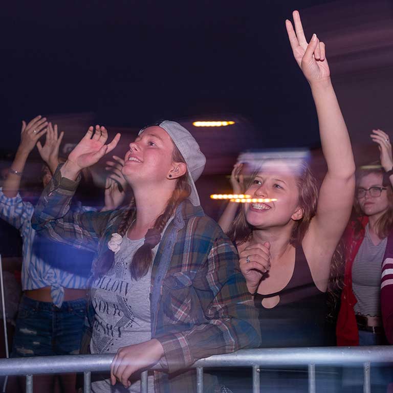 Students dance during Atlas Genius' set.