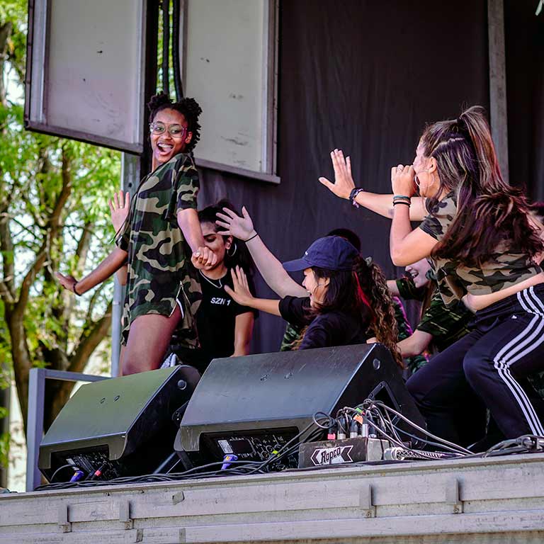 A dance group performs on stage at the Talent Showcase.