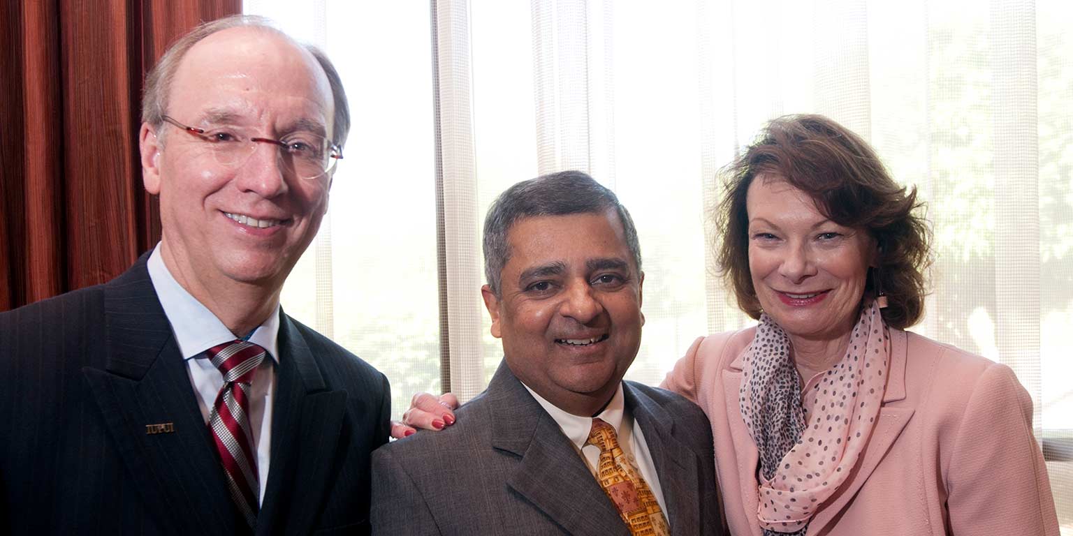 Former IUPUI Chancellor Charles Bantz stands with his wife Sandra Petronio and former Executive Vice Chancellor Uday Sukhatme.