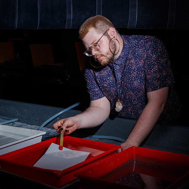 Zach Carrico uses the photography dark room in Herron School of Art.