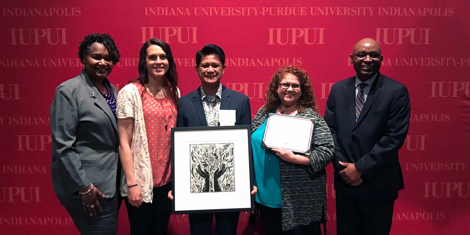 Merlin Gonzales and people from IUPUI's Division of Student Affairs while he was honored at the 2018 Spirit of Philanthropy luncheon.