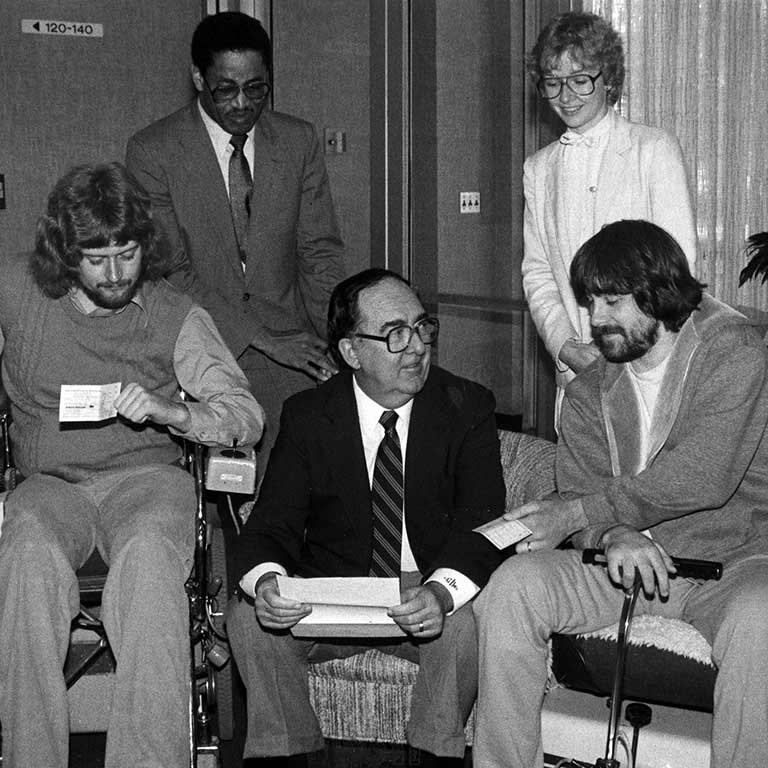 Former Chancellor Glenn Irwin sits with some students.