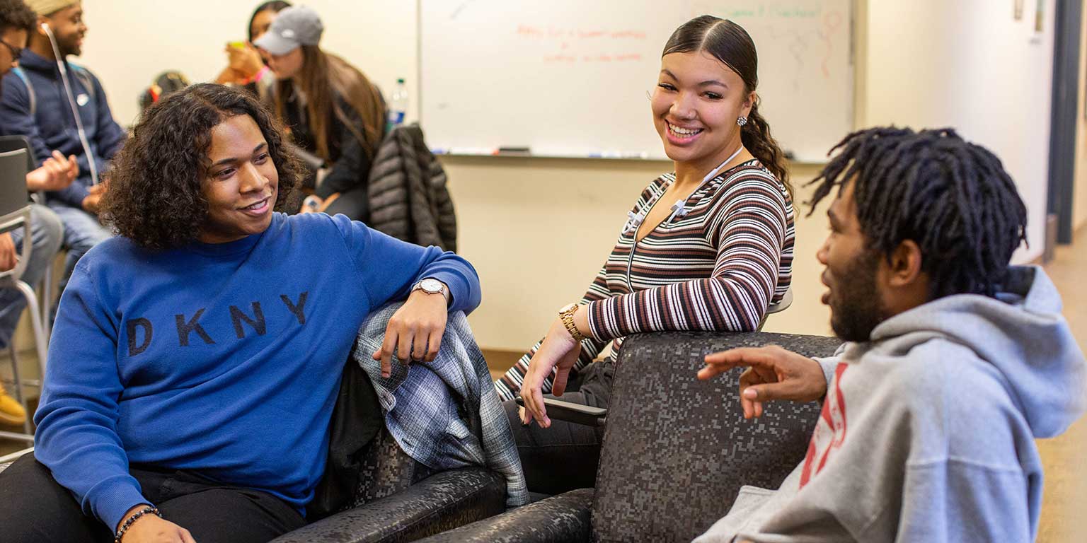 Breon Johnson chats with some peers in the Diversity Enrichment and Achievement Program office.