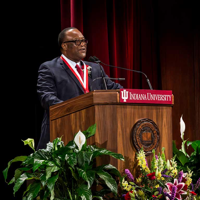 Lacy Johnson speaks at a podium as he's honored with IU's Distinguished Alumni Service Award.