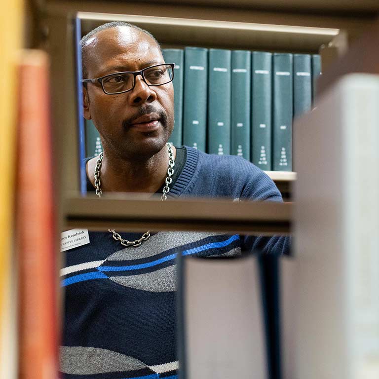 James Kendrick examines the stacks in University Library.