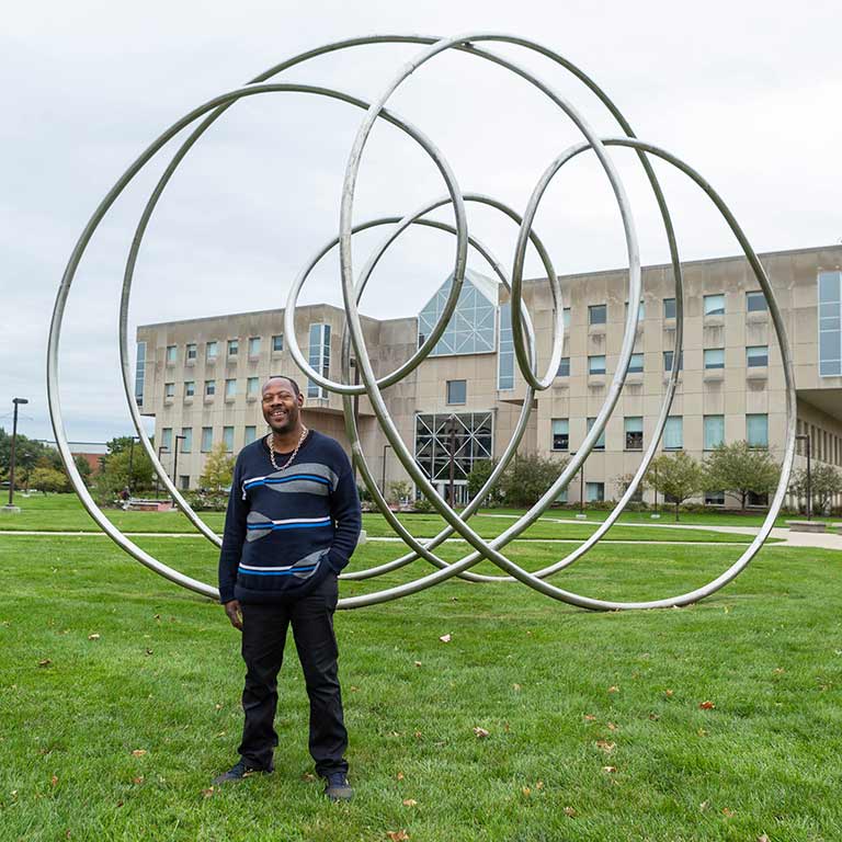 James Kendrick stands outside of University Library.