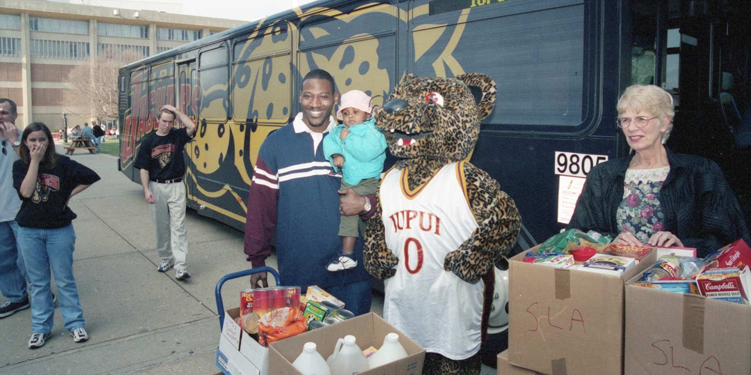 Jake Manaloor as Jinx the mascot during a Jam the Jaguar Bus food donation event in 1999.