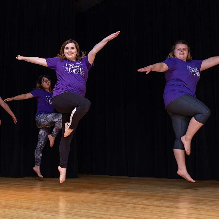 Meghan Nowels leaps during a dance warm-up.