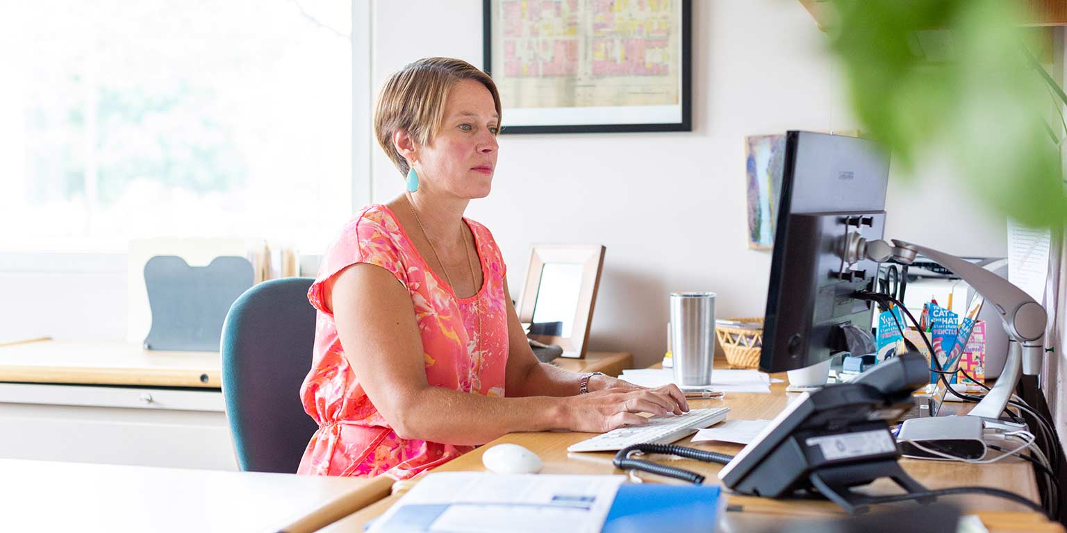 Kristi Palmer works at her desk