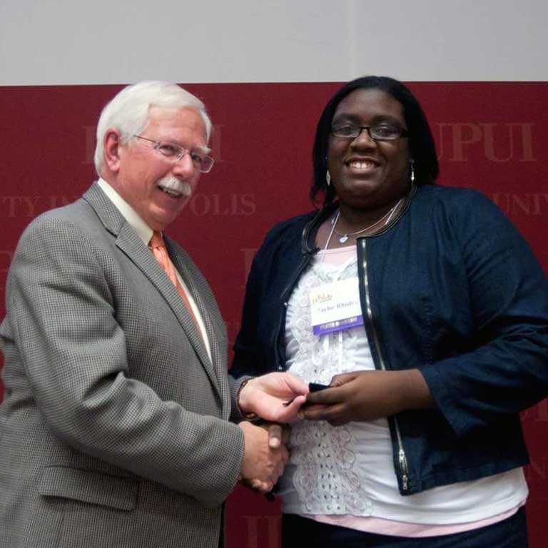 Taylor Rhodes receiving one of her Plater Medallions from William Plater.