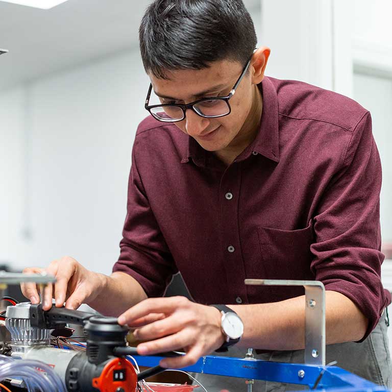 Sohin Shah works on a autonomous vehicle he helped develop.