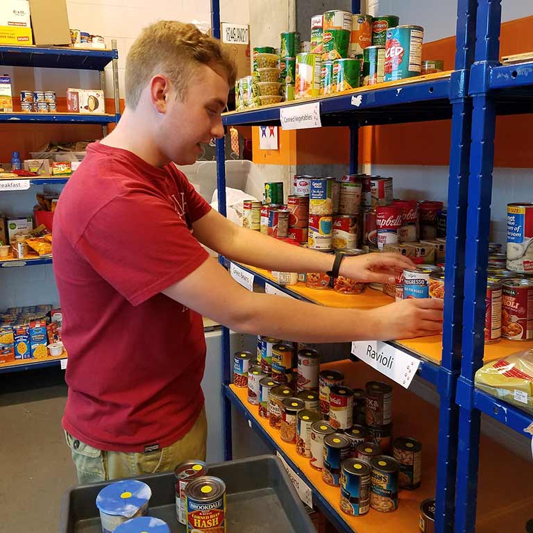 Michael Stottlemyer stocks shelves at the old location of Paw's Pantry.